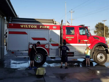 Wilton Fire Protection District Firefighters Washing Firetruck